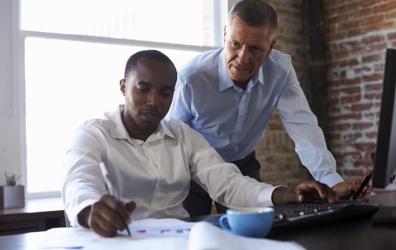 Businessmen Working On Computer In Office